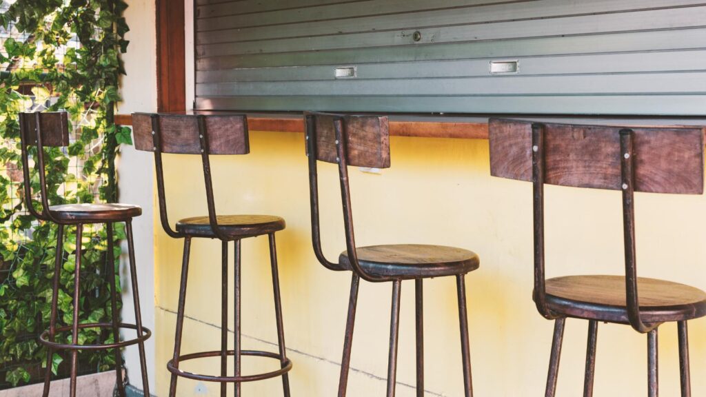 vintage style barstools outside bar.