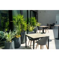Elements Outdoor Laminate Table Tops next to potted plants