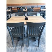 Square natural butcher block table tops placed in a restaurant