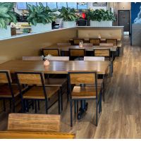 Square pecan butcher block tables placed in a restaurant