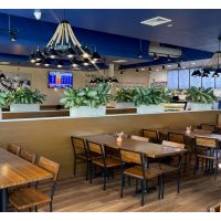 square pecan butcher block table tops placed in a restaurant