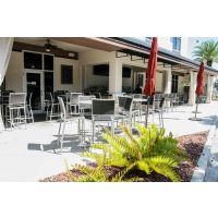 Spun metal table tops shown with barstools