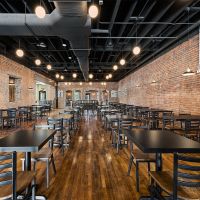 Urban laminate tables in industrial restaurant